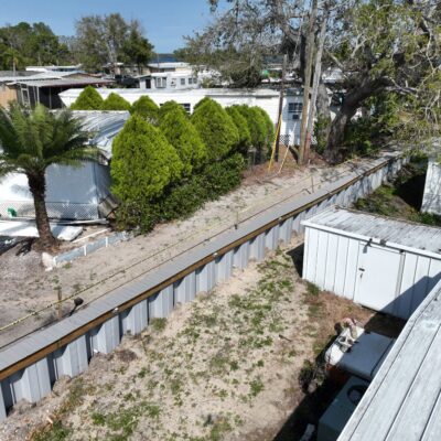 Inland retaining wall with composite cap